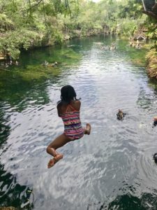 Cliff jumping at Cenote Jardin del Eden